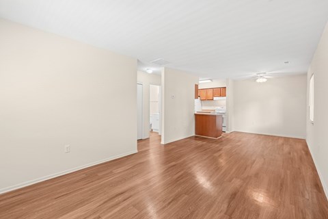 A room with wooden flooring and white walls.