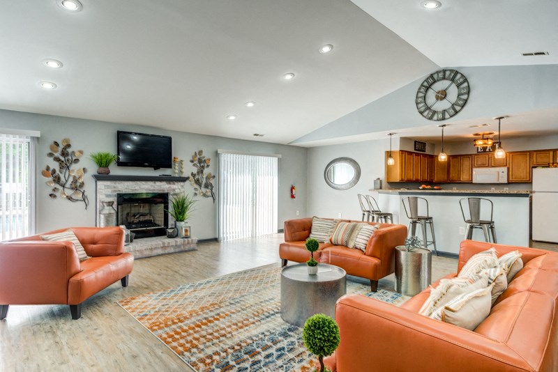 Clubhouse interior with vaulted ceilings, hardwood style flooring, and a colorful rug