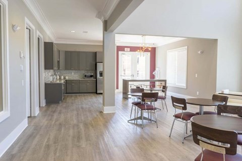 A kitchen with a dining table and chairs.