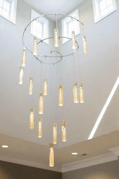 A chandelier with multiple lights hanging from the ceiling at Foxwood Apartments, North Carolina, 27616