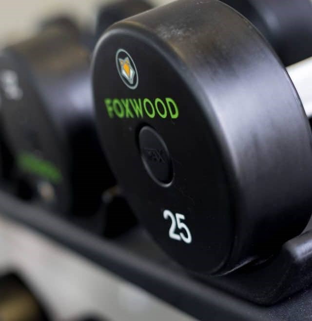 A close up of a black dumbbell with the word FOXWOOD and the number 25 printed on it at Foxwood Apartments, Raleigh-Durham, North Carolina