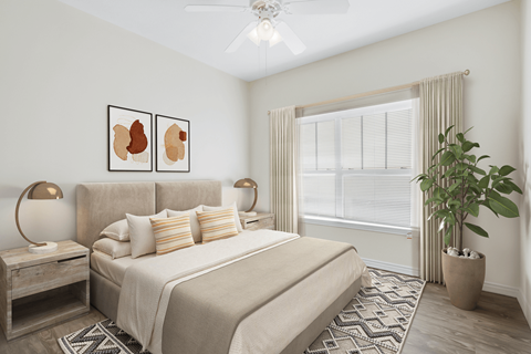 A bedroom with a large bed and a potted plant.