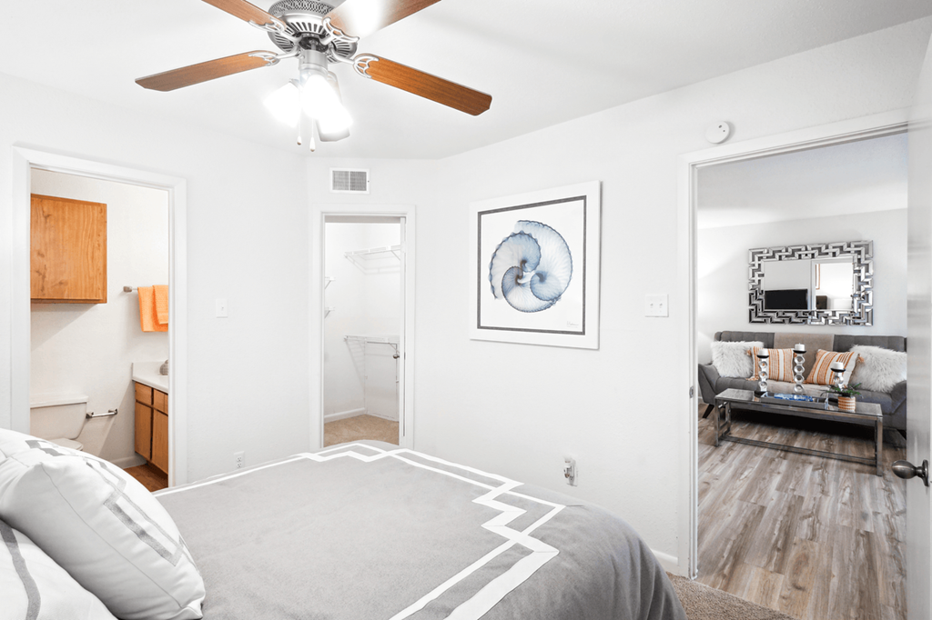 a bedroom with a bed and a ceiling fan