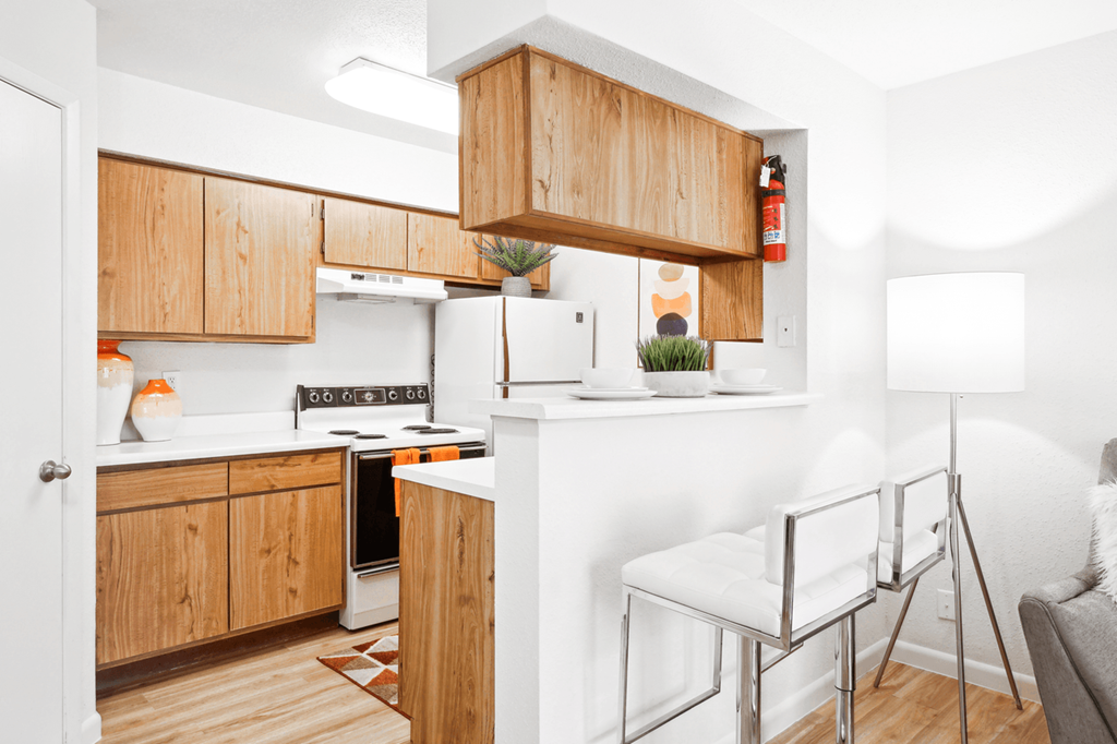 a kitchen with wooden cabinets and a white counter top