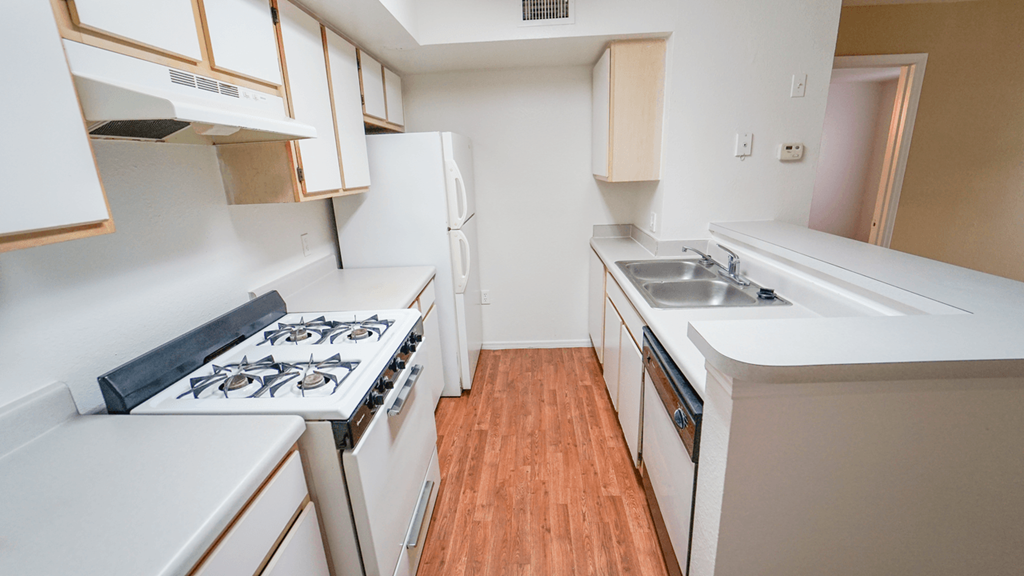 a kitchen with white cabinets and white appliances