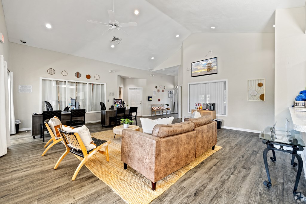 A living room with a couch, chairs, and a coffee table.
