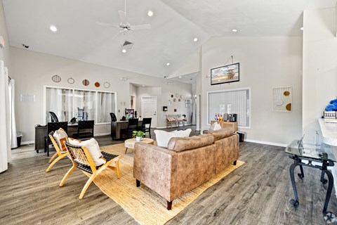A living room with a couch, chairs, and a coffee table.