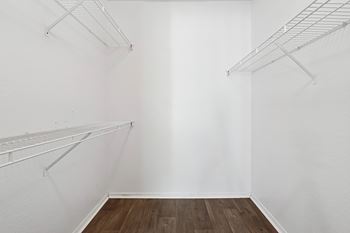 Empty room with white walls and wooden floor.