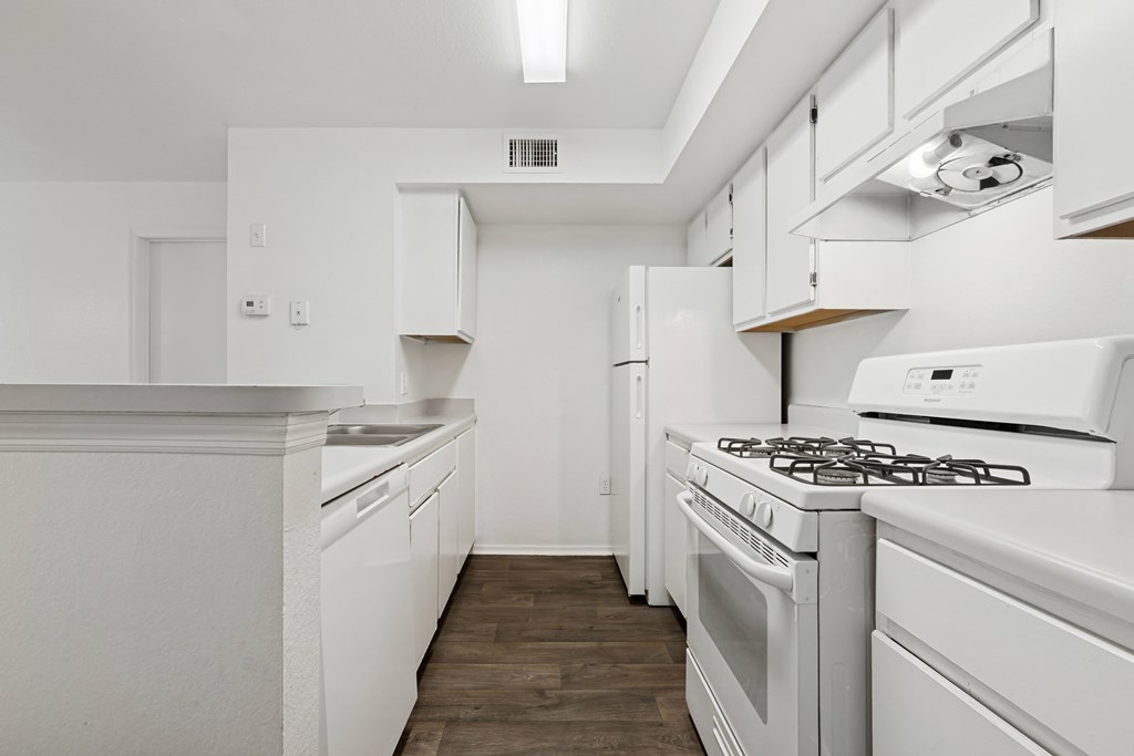A white kitchen with a stove and oven.