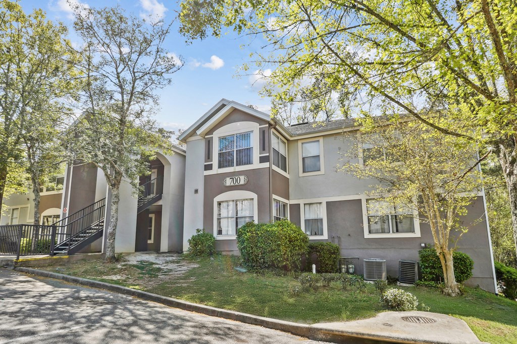 A two-story house with a garage and a driveway.