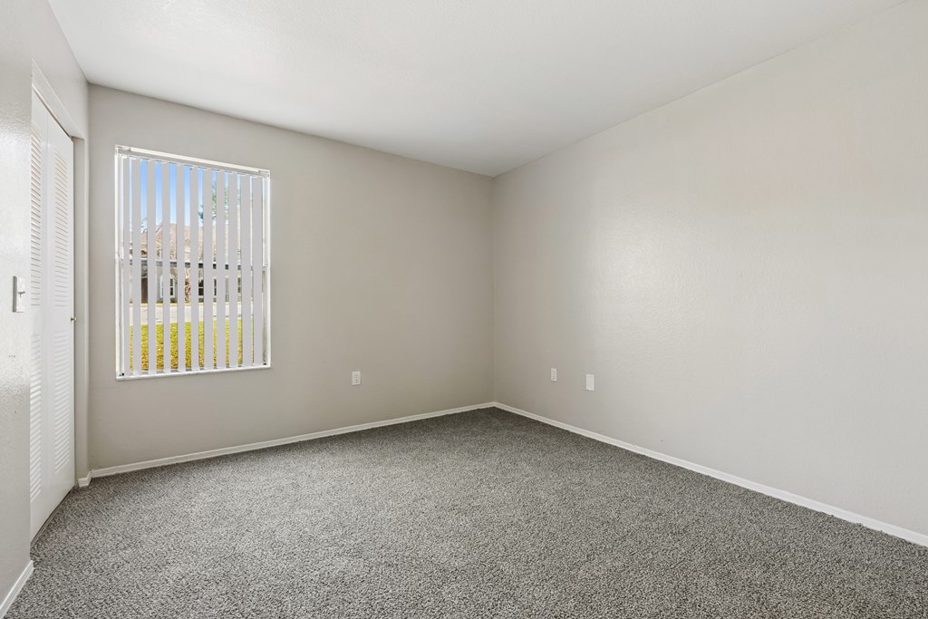 A room with a window and a door.