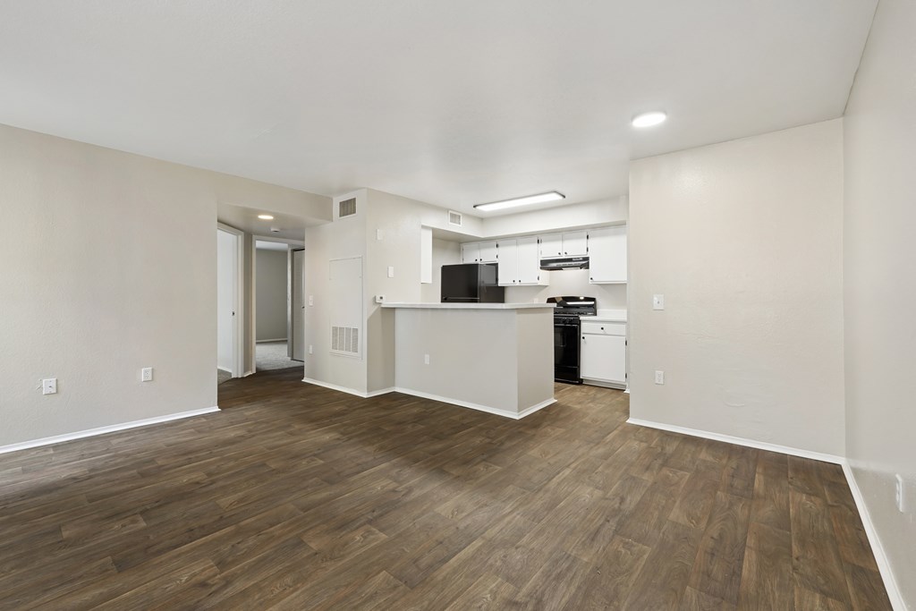 A kitchen area with a dishwasher and a refrigerator.