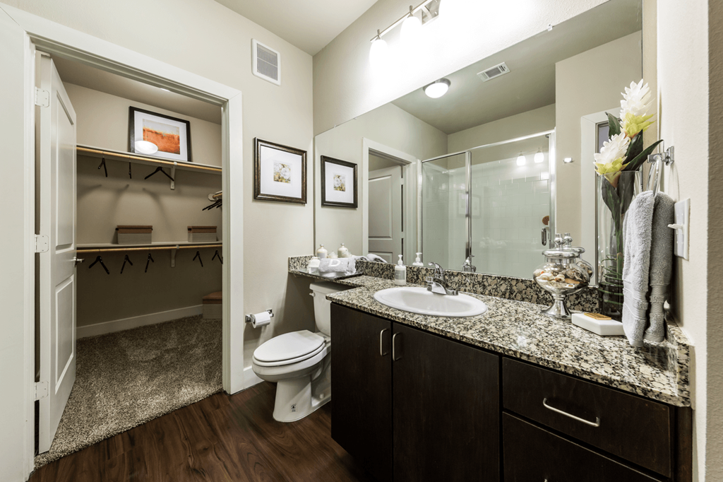 a bathroom with a toilet sink and shower