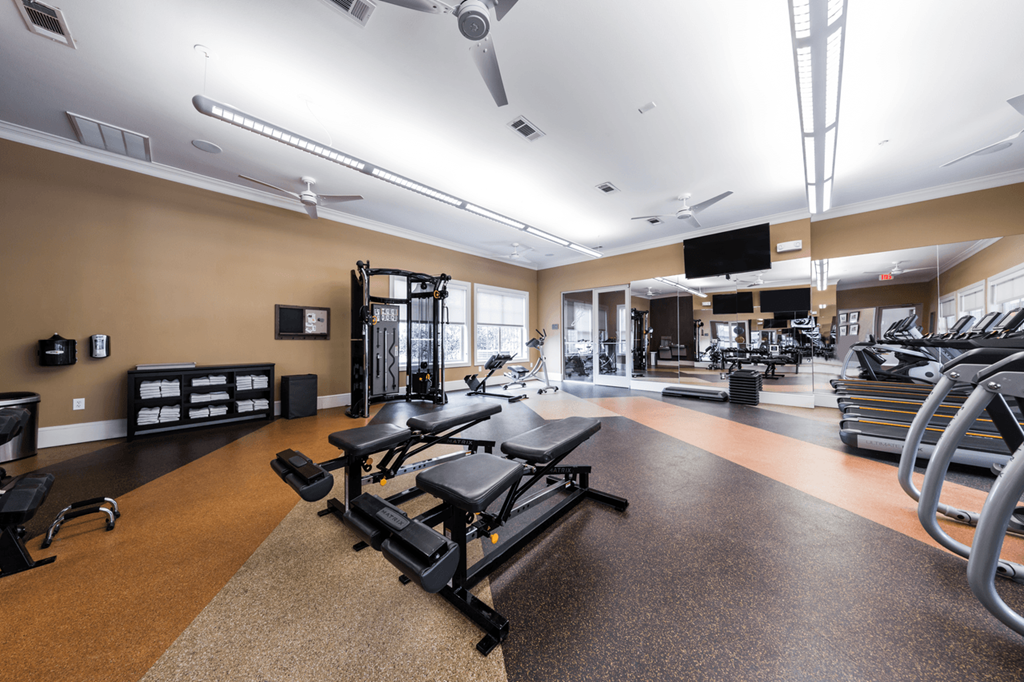 a spacious fitness center with treadmills and other exercise equipment