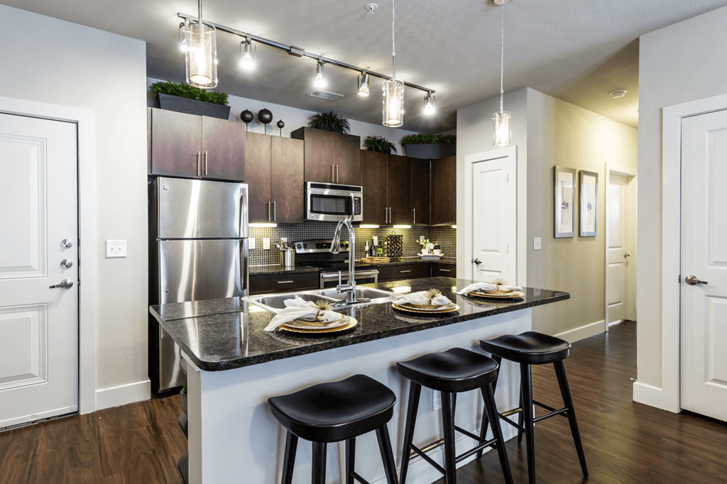 a kitchen with an island and three stools