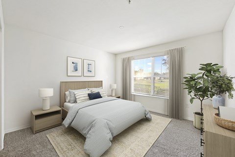 a bedroom with a large window and a bed with a striped comforter