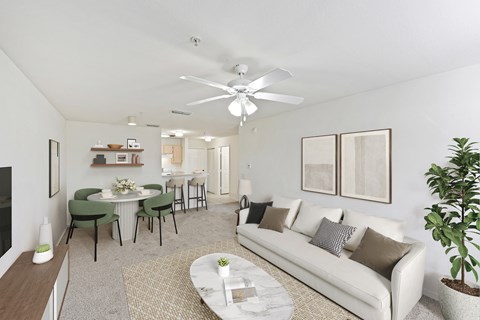 A living room with a white couch, a coffee table, and a dining table with chairs.