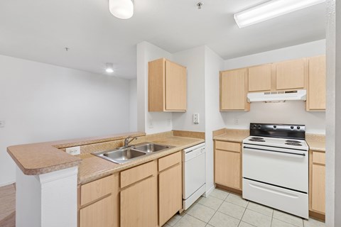 A kitchen with wooden cabinets and white appliances.