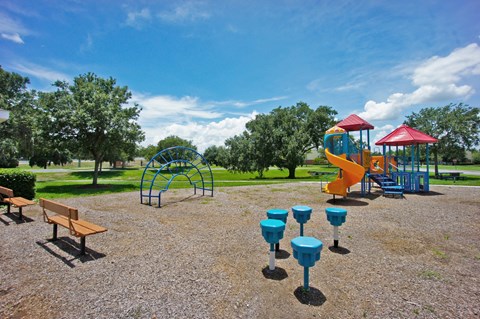 a playground with a slide and picnic table