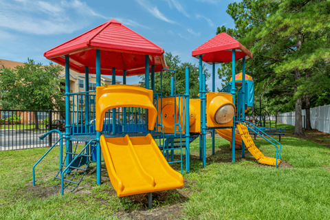 a playground with a colorful swing set and slides