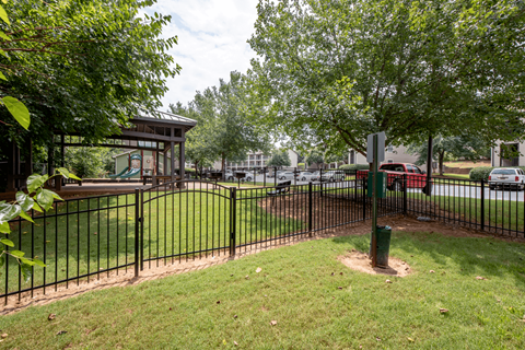 the gate to the park is locked and there are cars parked in the lot
