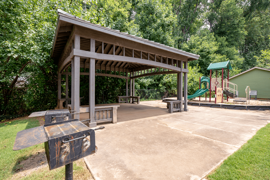 a pavilion with a playground in a park