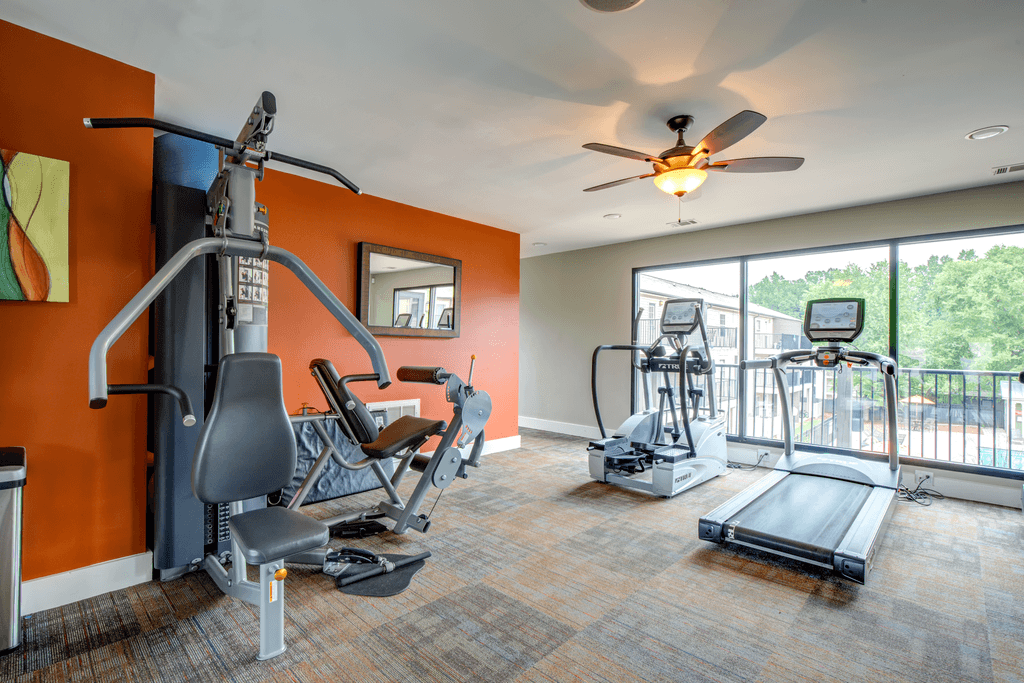 the gym has plenty of equipment and a large window
