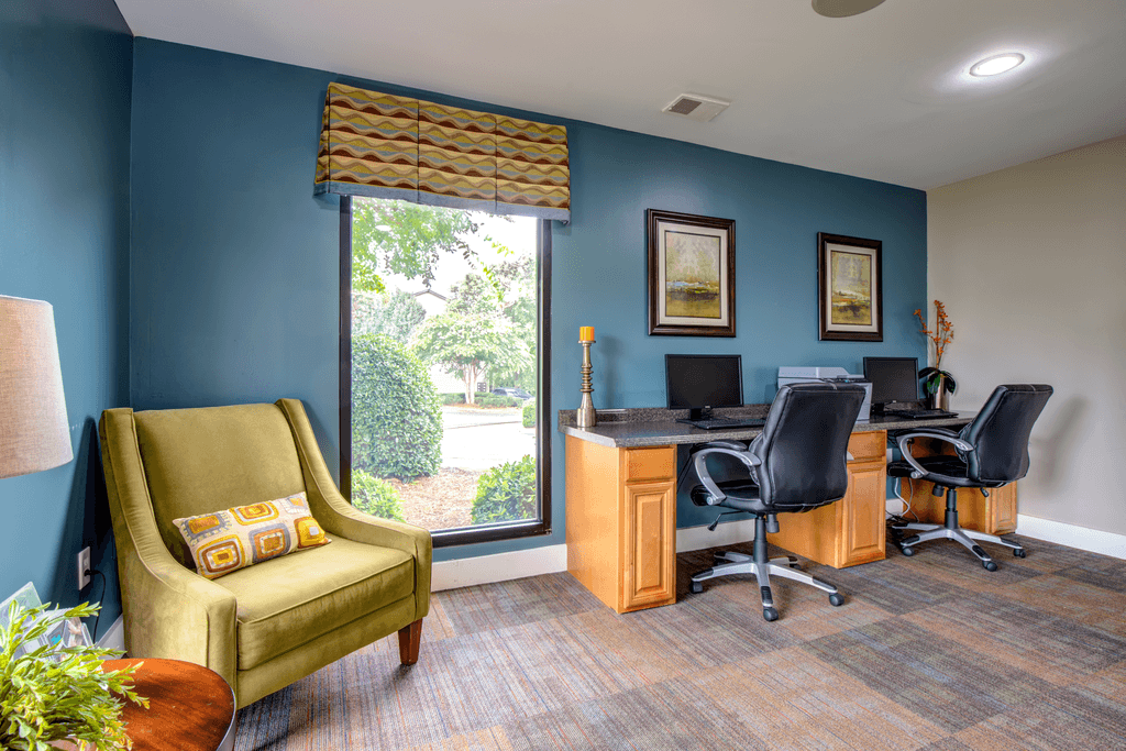 a home office with a desk and a window