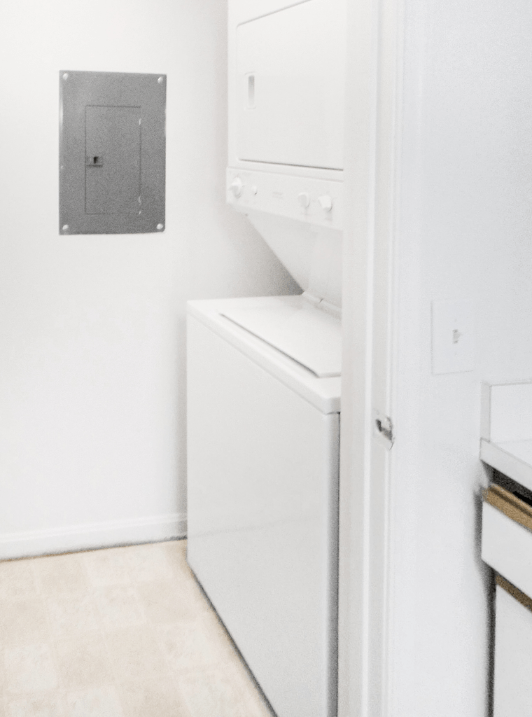 In unit stackable washer/dryer in utility closet next to breaker box