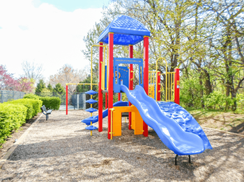 Outdoor playground with slide with wood chips underneath