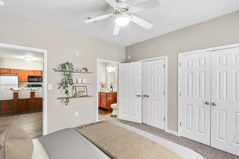 A living room with a ceiling fan and a rug on the floor.