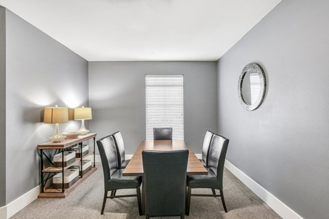 a dining room with a table and chairs