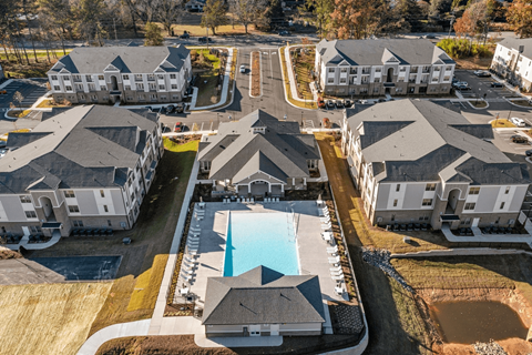 A bird's eye view of a residential complex with a swimming pool.
