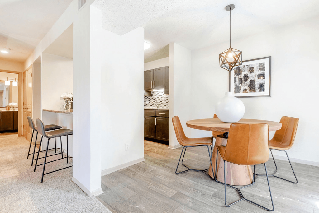A dining room with a white table and chairs at Madison Southpark Apartment Homes, Charlotte, NC, 28226