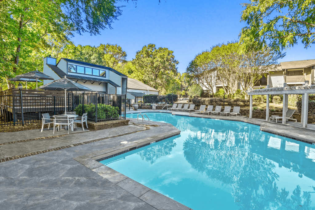 A swimming pool surrounded by a deck and lounge chairs at Madison Southpark Apartment Homes, Charlotte, NC, 28226