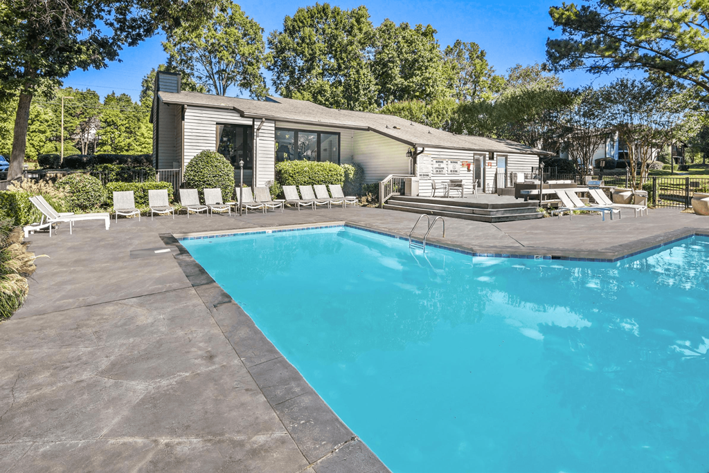 A swimming pool in front of a house at Madison Southpark Apartment Homes, Charlotte, 28226
