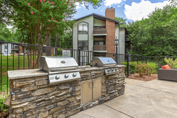 A stone wall with a grill on top of it at Madison Southpark Apartment Homes, North Carolina, 28226