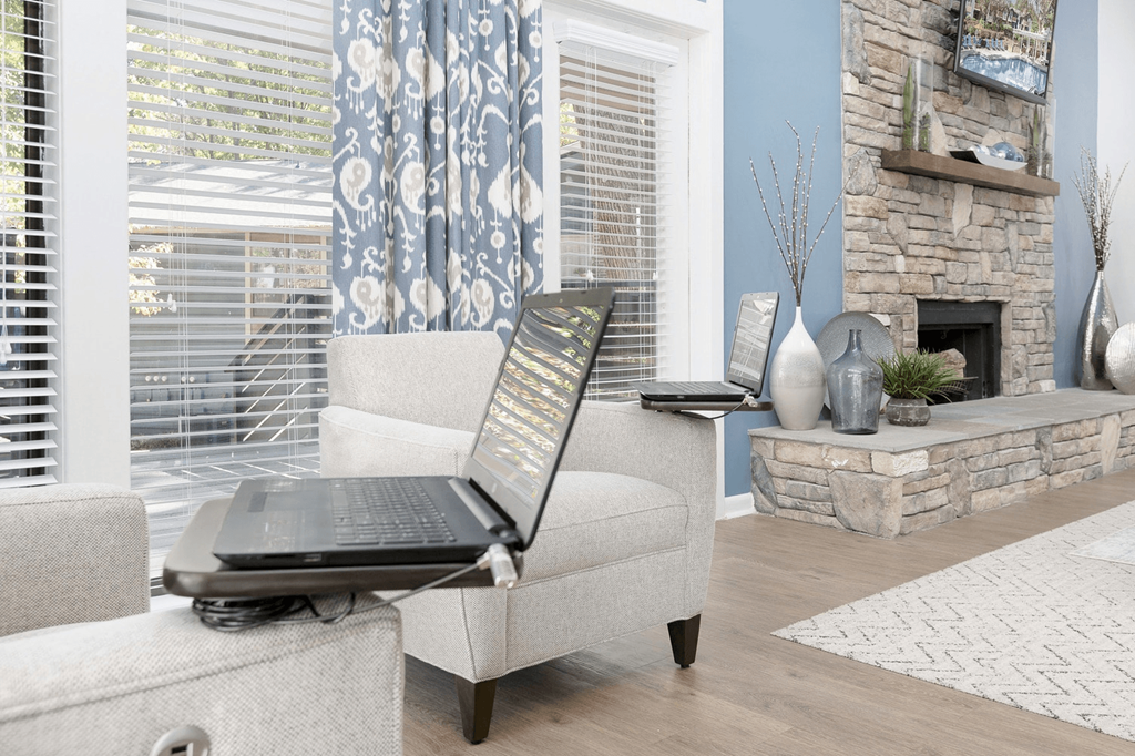 A laptop is open on a couch in a living room at Madison Southpark Apartment Homes, Charlotte, North Carolina