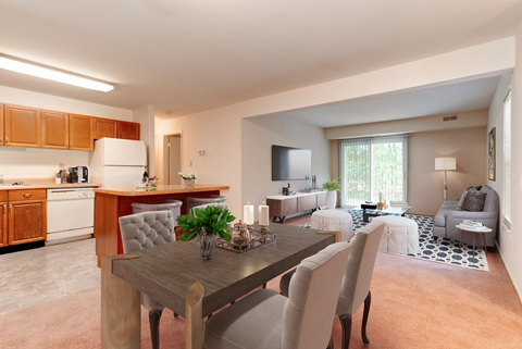 A modern kitchen with a dining table and chairs.