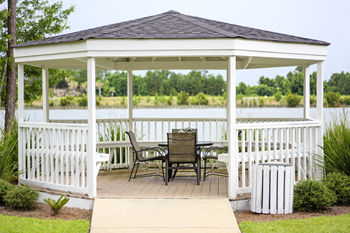 a gazebo with a table and chairs on it