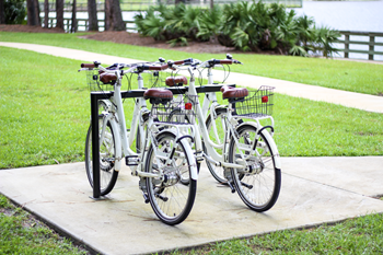 a row of bikes parked on a sidewalk