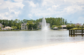 a view of a lake with a fountain in the middle of it