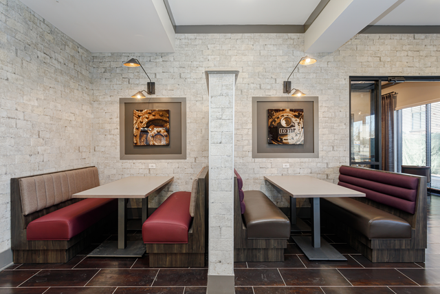 a dining room with two tables and benches and two chairs