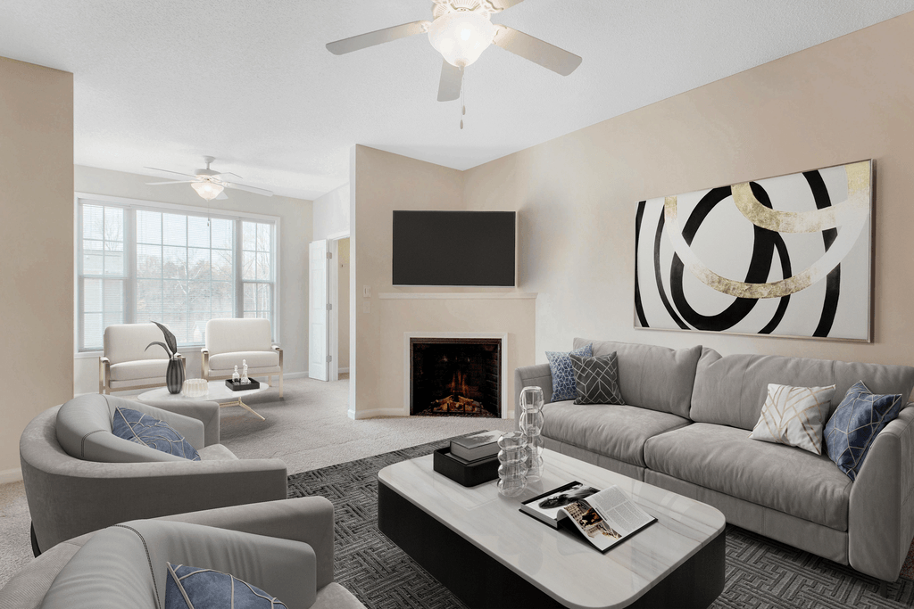 staged living room with carpeted flooring, ceiling fan, and fireplace at Ashley Court Apartments, Charlotte, 28262