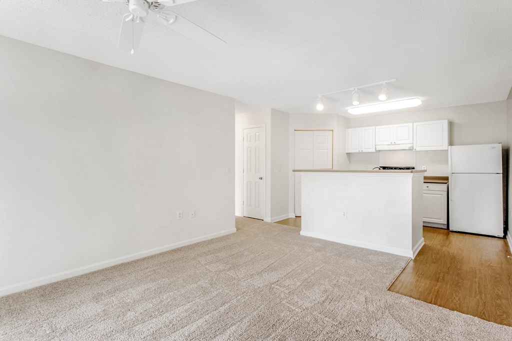 A white kitchen with a refrigerator, stove, and cabinets. at The Grayson Apartment Homes, Charlotte, North Carolina