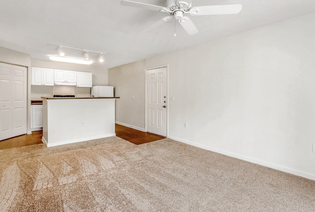 A room with a ceiling fan and carpeted floor. at The Grayson Apartment Homes, Charlotte, 28262