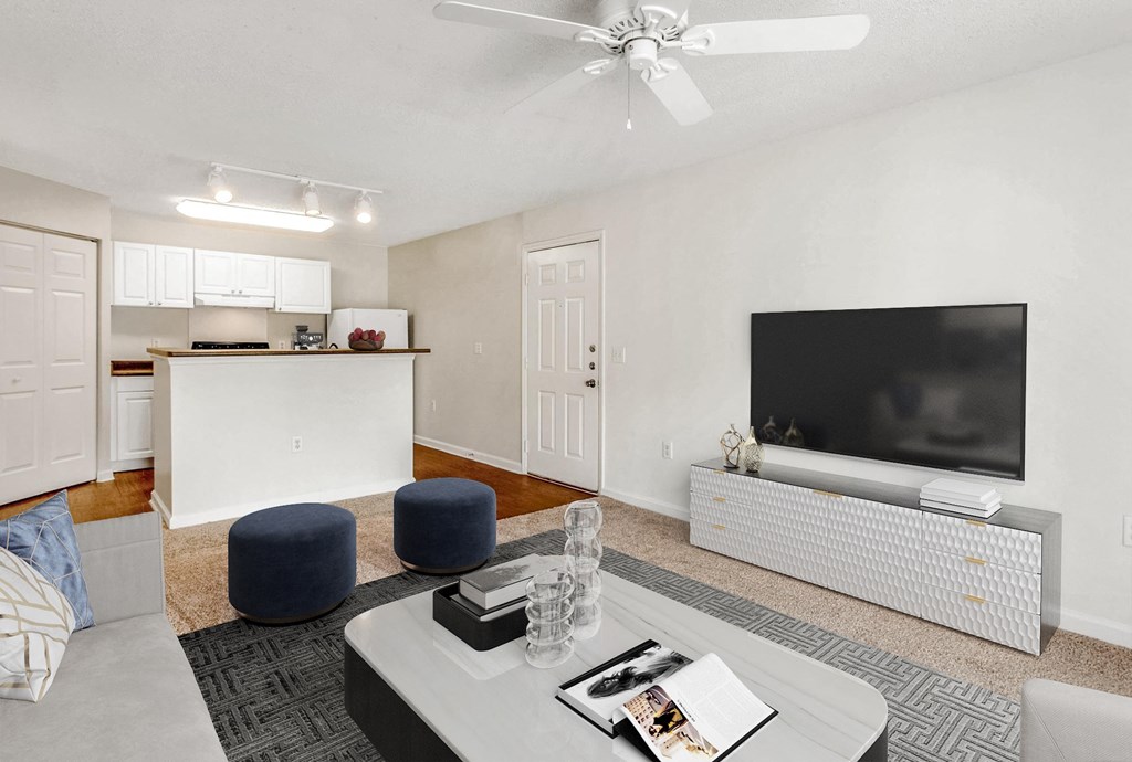 A living room with a white ceiling fan and a flat screen TV. at The Grayson Apartment Homes, North Carolina, 28262