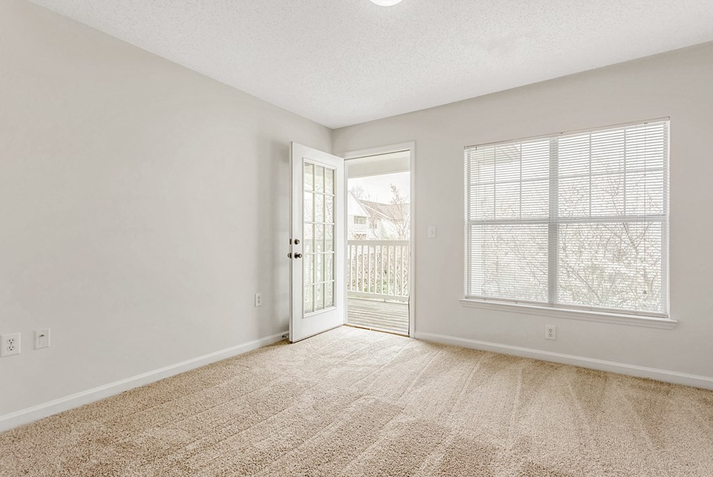 A room with a carpeted floor and a window with blinds. at The Grayson Apartment Homes, Charlotte, 28262