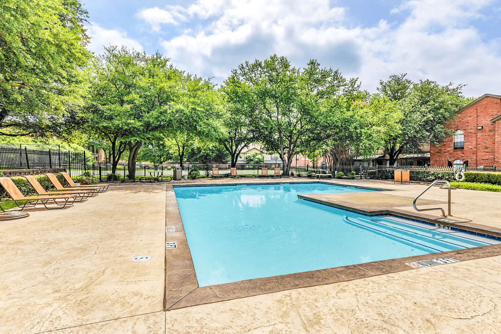Swimming pool with lounge chairs, picnic table and native landscape