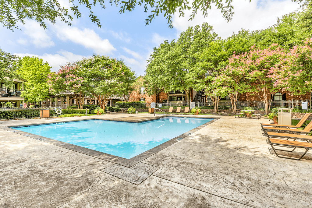 Swimming pool with lounge chairs, picnic table and native landscape